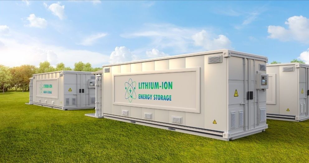 Large "Lithium-Ion Energy Storage" containers sit in a field.