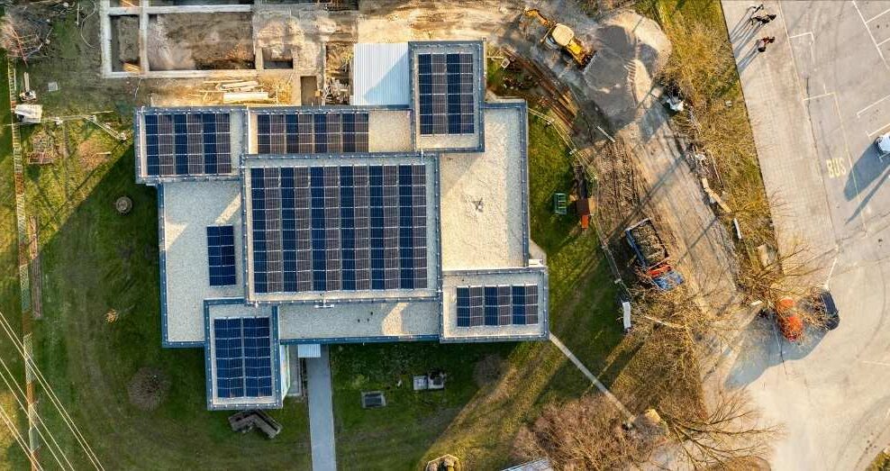 An aerial view of a building with solar panels.