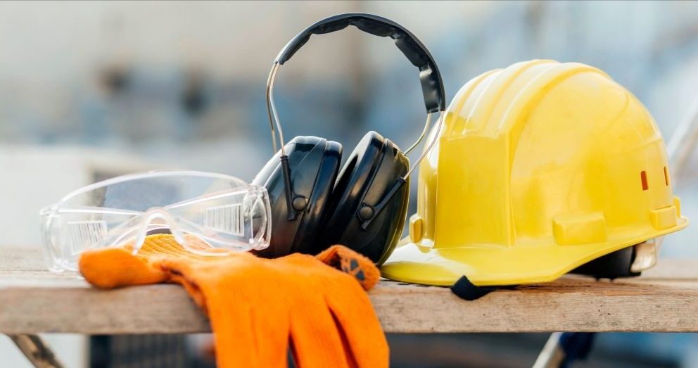 A yellow hard hat, safety glasses, and gloves.